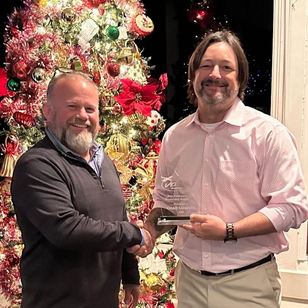 Chad Sanders receiving the Tom Ventresco Leadership Award from VP Aviation owner Benji Farr.
