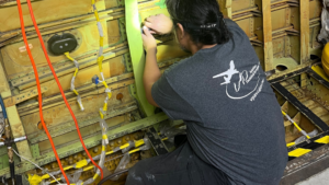 VP Aviation technician working on exposed aircraft structure during a complex aircraft repair on a B737